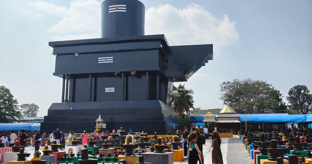 The 108 ft Shiva lingam at Kotilingeshwara Temple rising above a field of thousands of smaller stone lingas