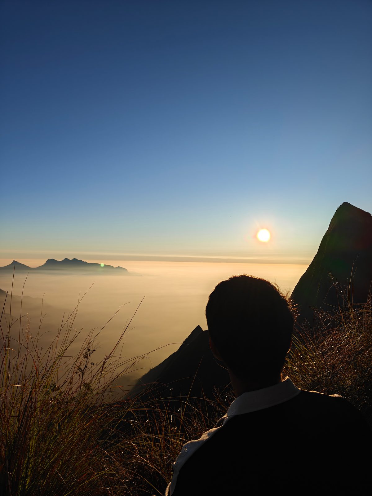 Sunrise above a sea of clouds seen from Kolukkumalai near Munnar